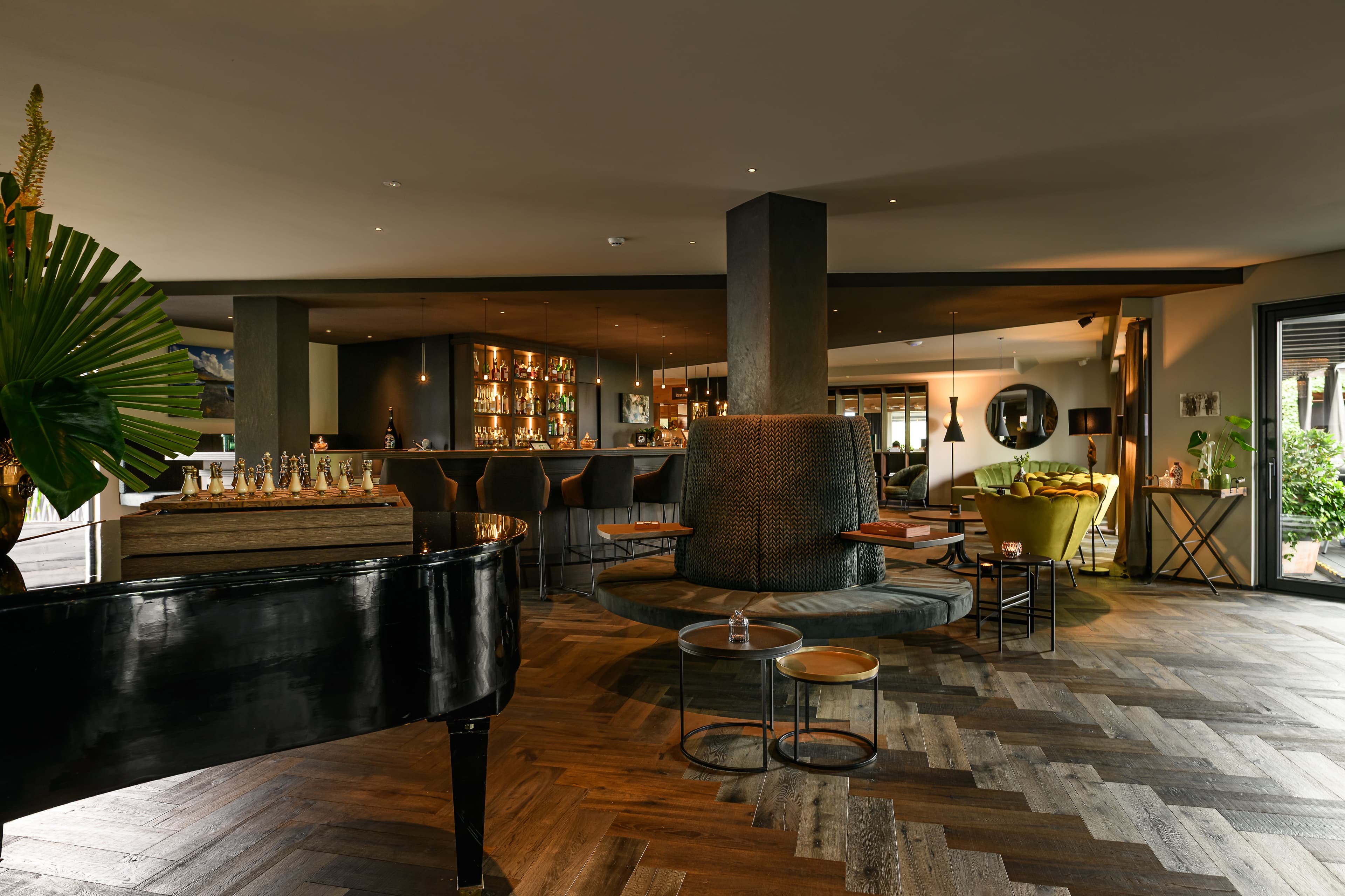Hotel bar and lounge with grand piano and herringbone floor - Hotel Tirolensis