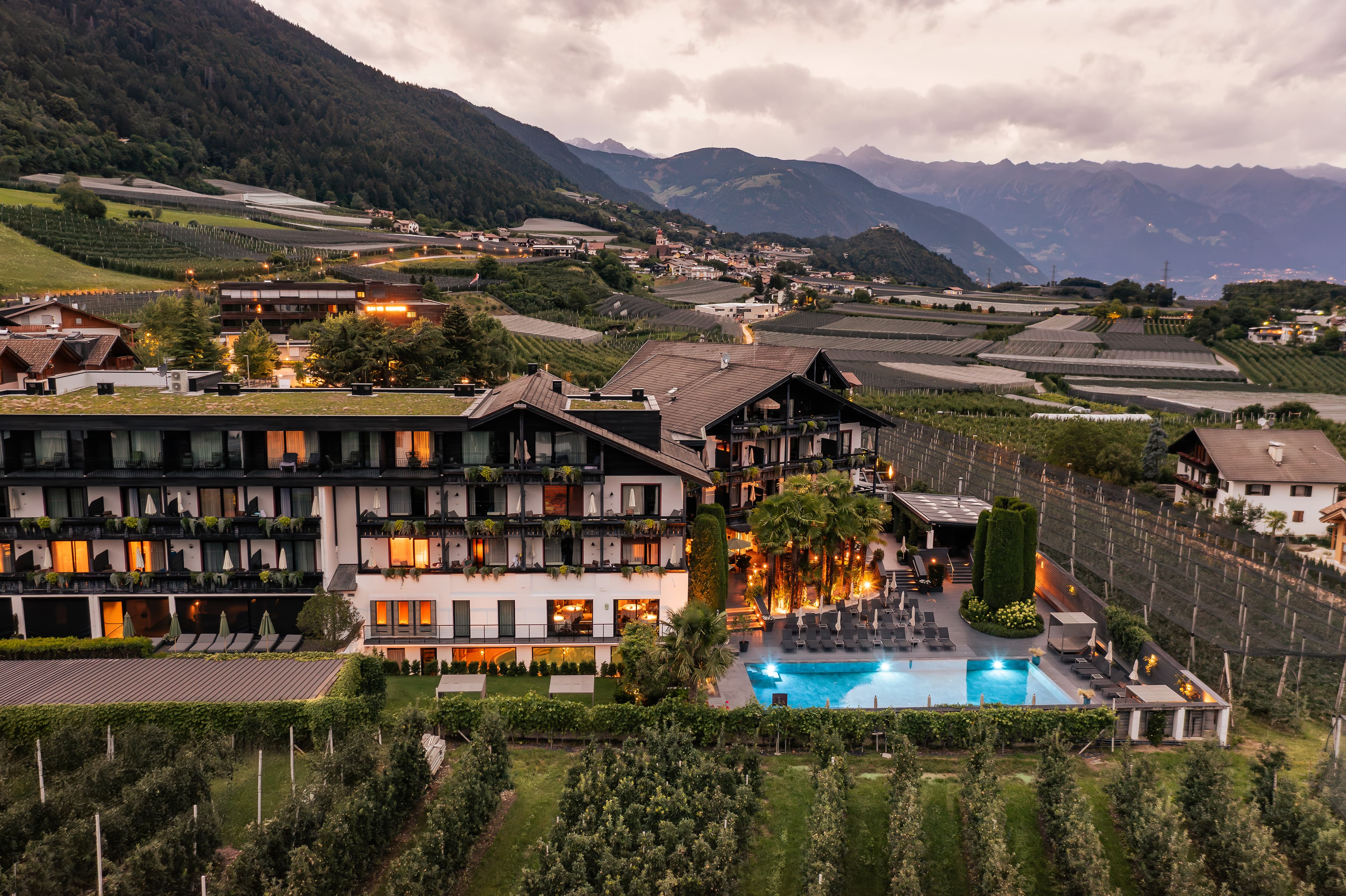 Dusk aerial of the hotel with the illuminated pool - Hotel Tirolensis