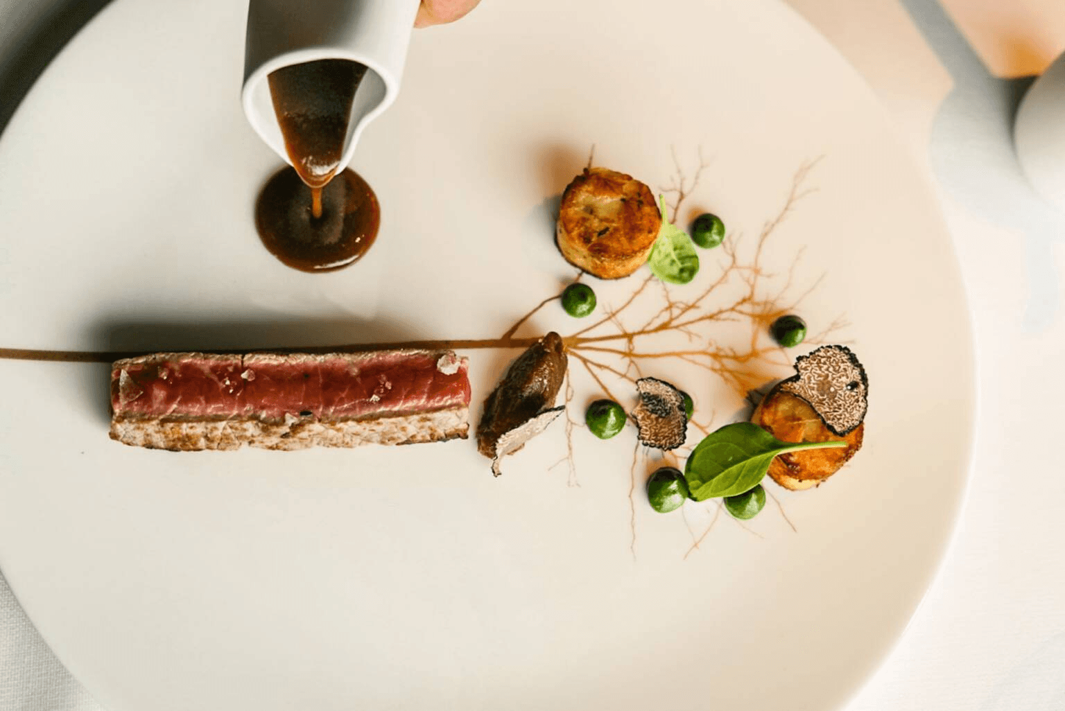 Golfer teeing off with mountain views